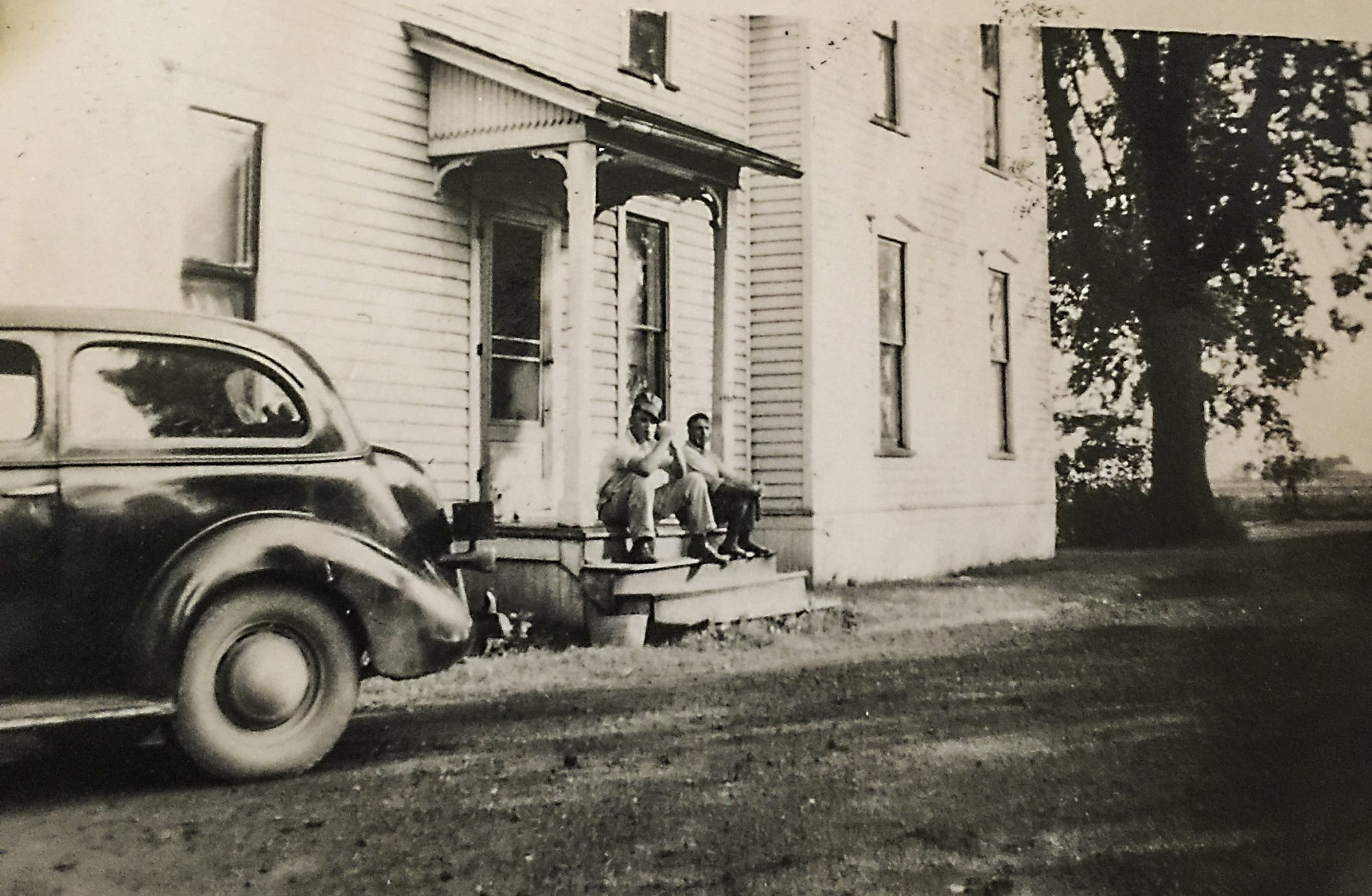 Herman and Coord Caspers with a car at Coord’s house, about 1943.