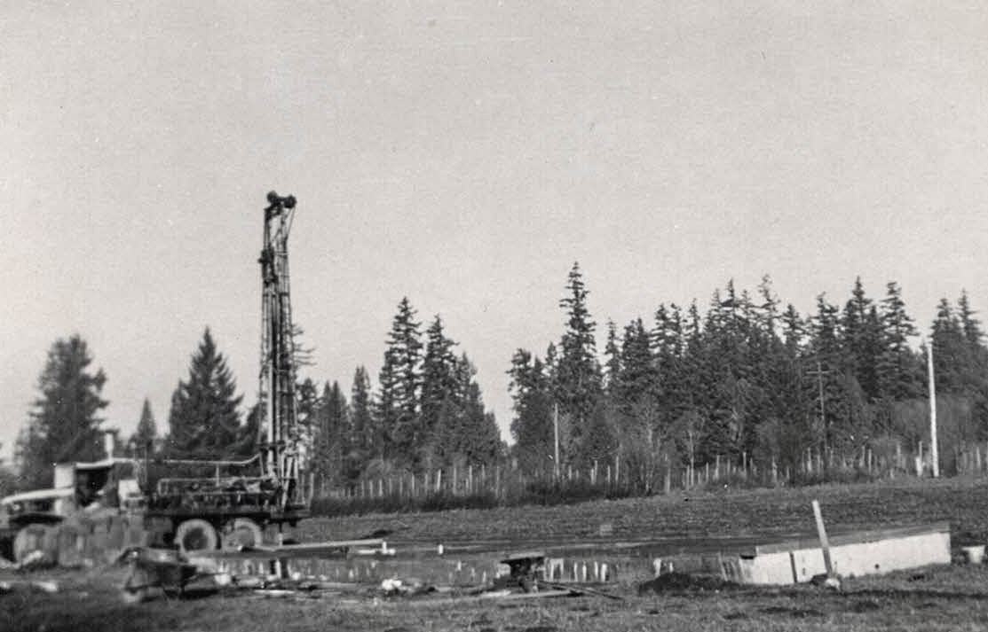 Well drilling rig, probably Water Service Company.